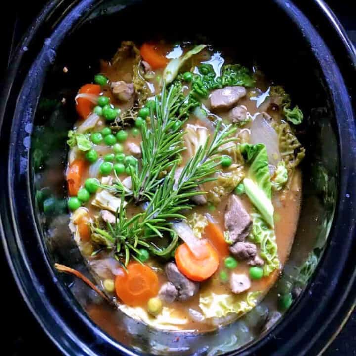Lamb casserole in slow cooker pot.