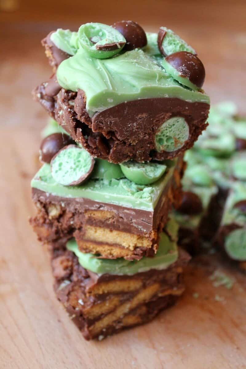 Mint Aero Chocolate Fridge Cake, a stack of three chunks of the traybake showing the mint aero bubbles and crushed biscuits inside
