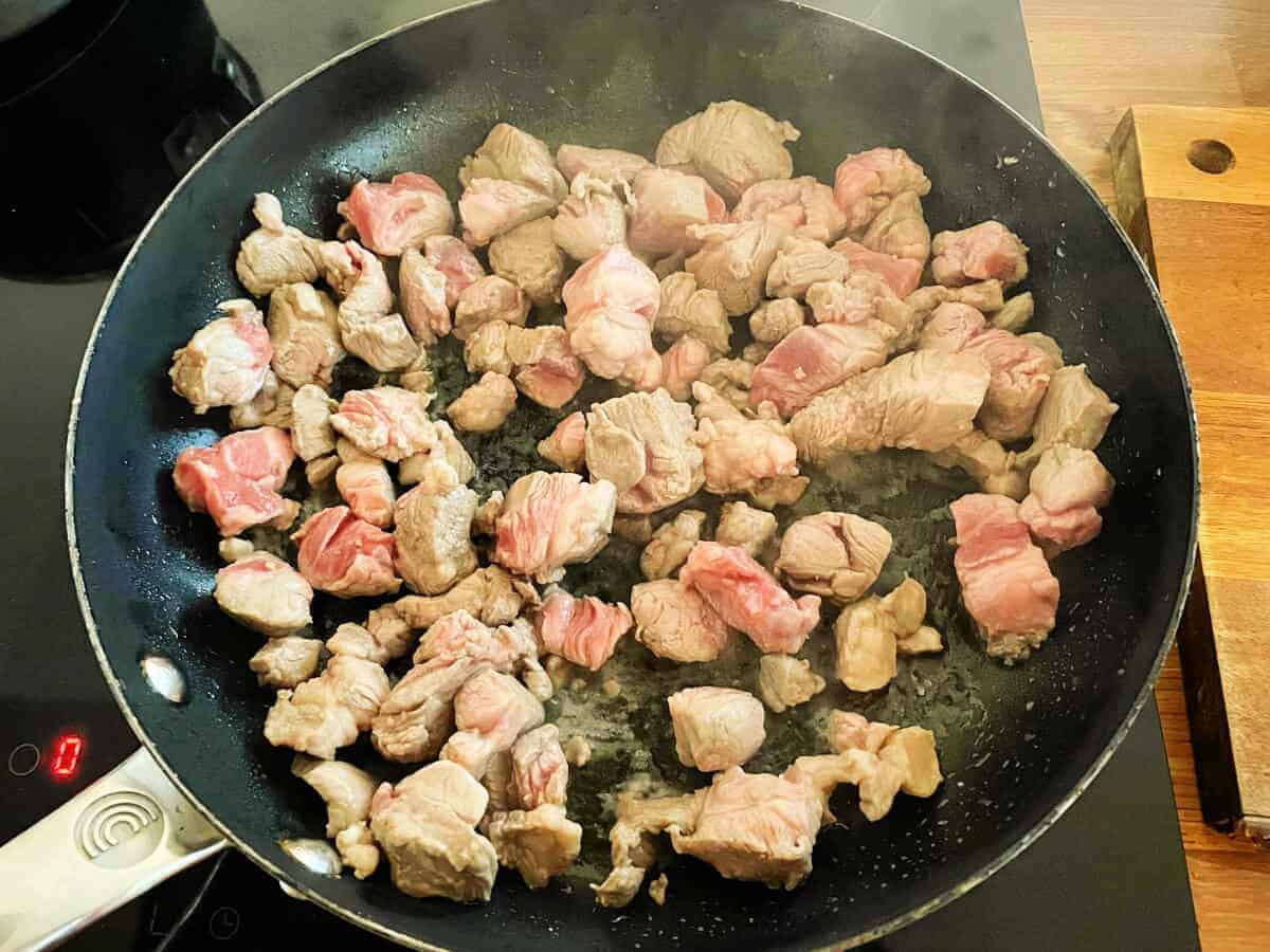 Diced lamb in a saucepan, in the process of being browned off.