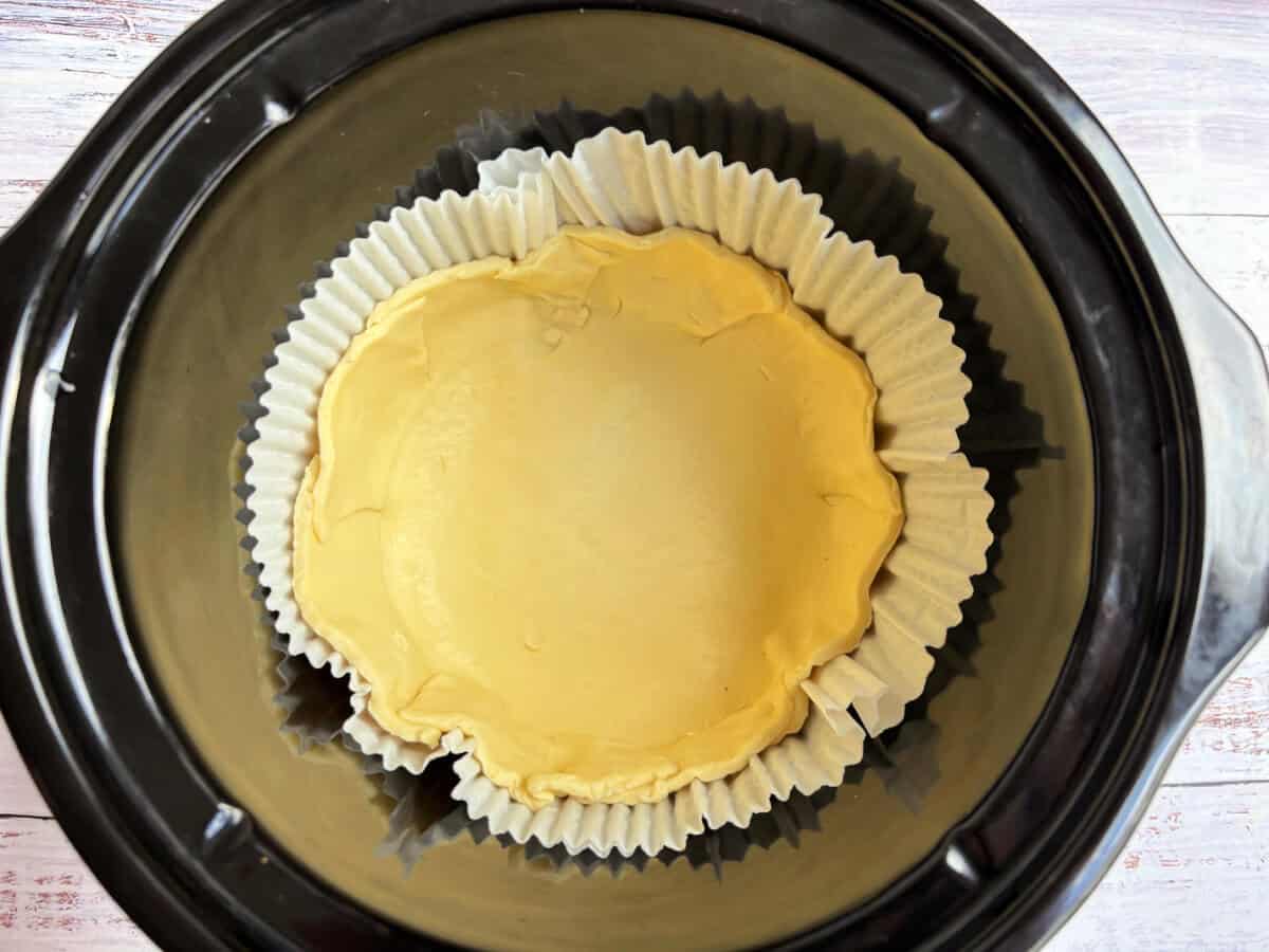 Pastry shell in slow cooker pot.