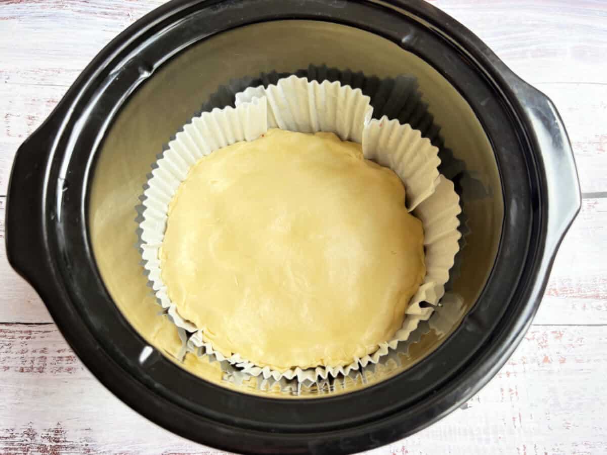 Pie in slow cooker pot, with lid added.