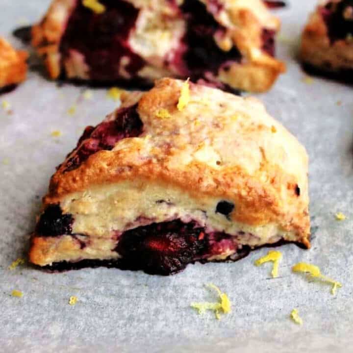 Close up of berry scone with lemon zest.