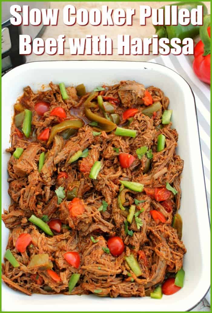 Pulled beef in a white serving dish with text overlay "Slow cooker pulled beef with harissa".