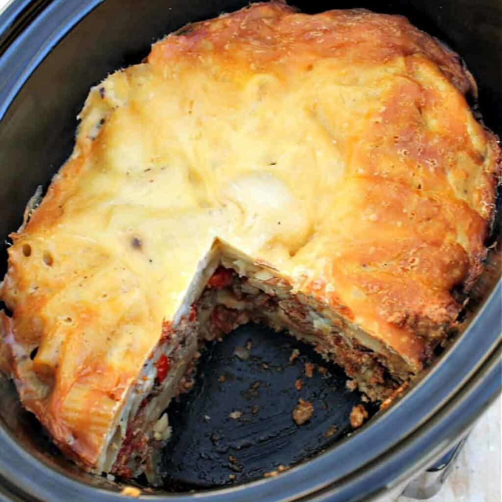 Close up of slow cooker pot with cooked dish ready for serving.