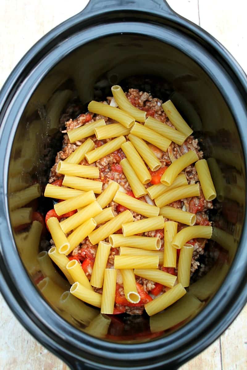 Assembling the slow cooker pastitsio - adding the first layer of pasta