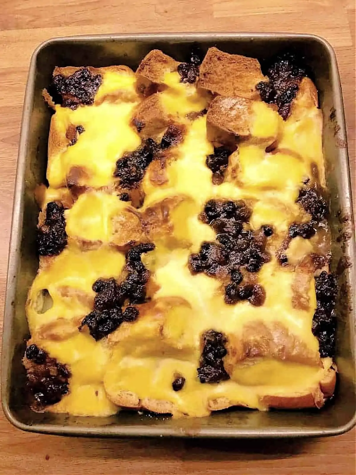An oven tray with bread and butter pudding just out of the oven.