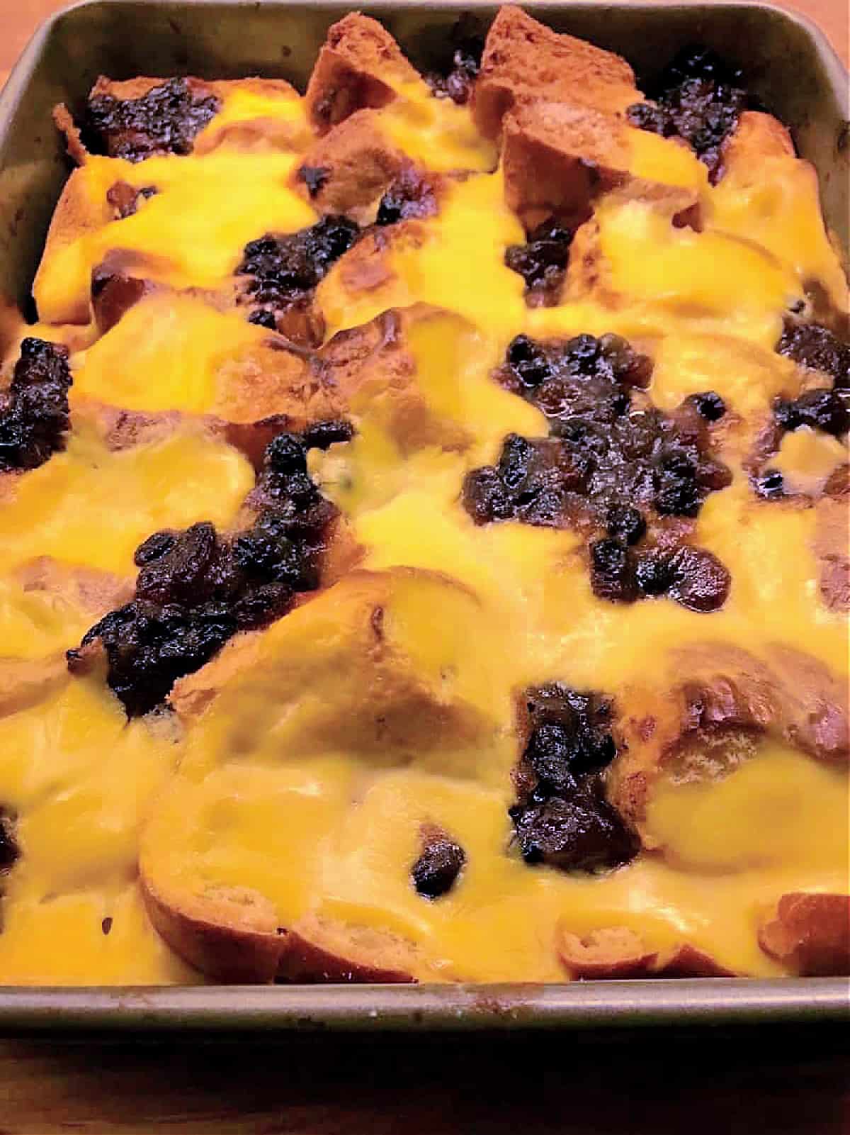 An oven tray with bread and butter pudding just out of the oven.