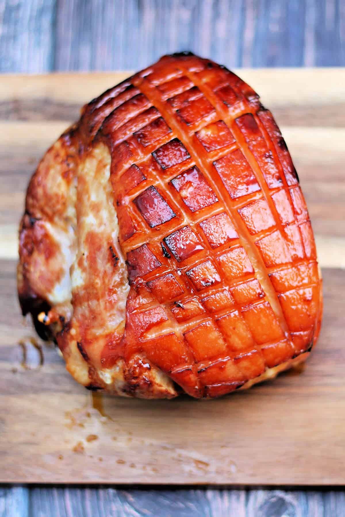 Gammon joint with a sticky maple glaze on a board.