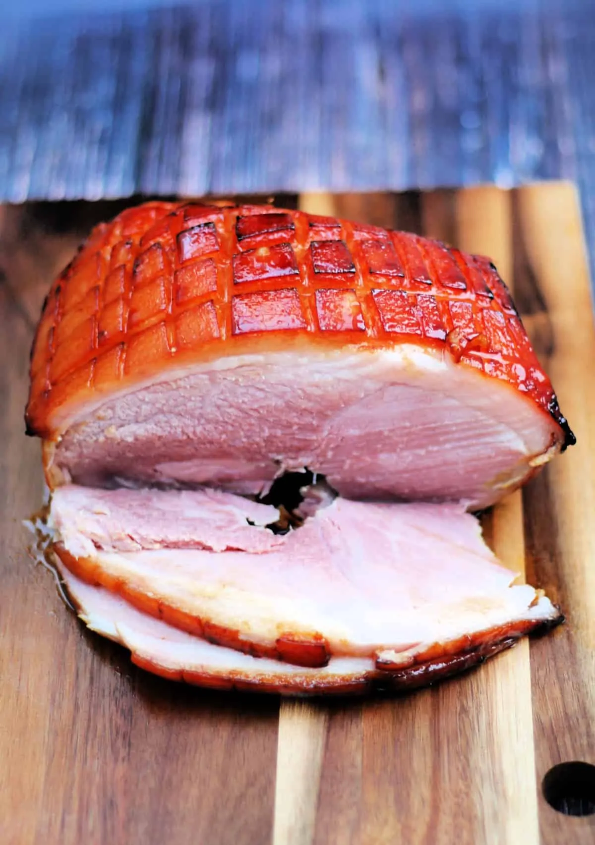 Sliced ham joint on a wooden board.