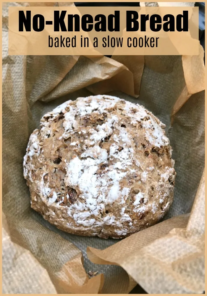 Slow cooker bread in pot on parchment.