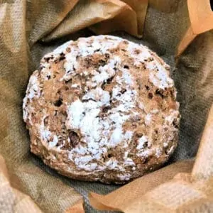 Close up of rustic bread in baking paper.