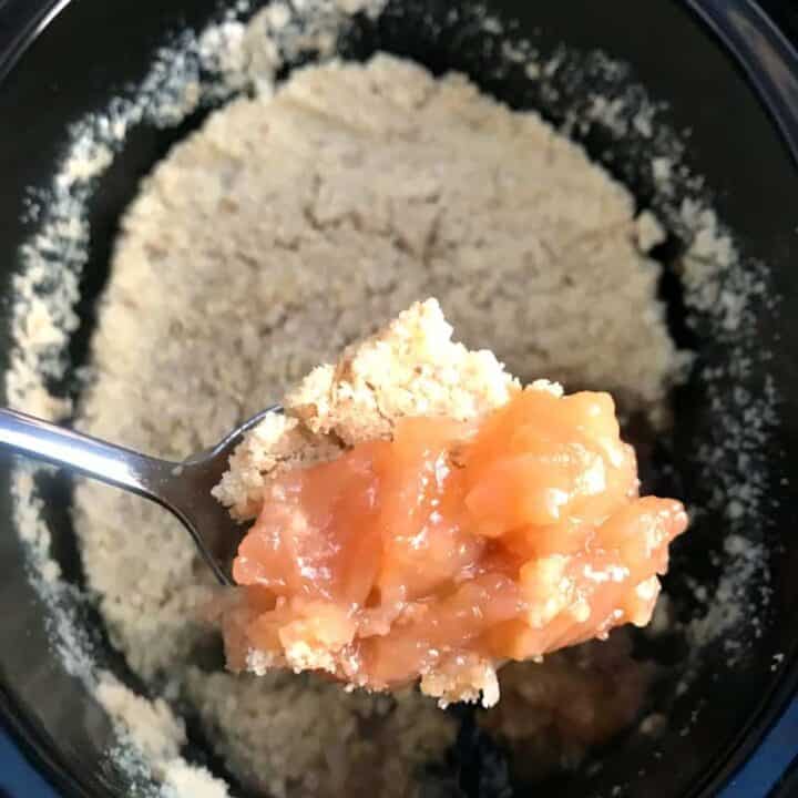 Slow cooker apple crumble, served on a spoon