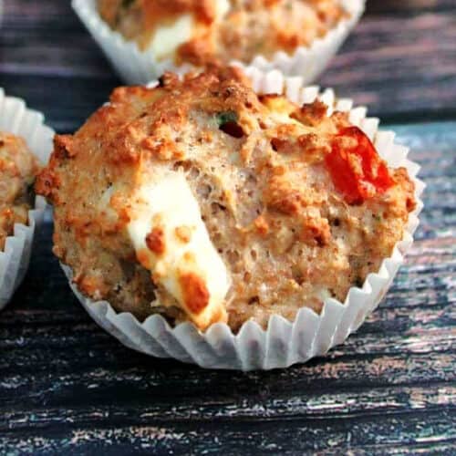A feta and red pepper muffin in a white case.