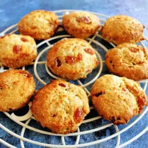 Scones on a white round rack on a blue background.