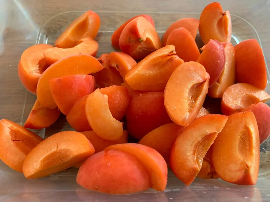 A tub of chopped fresh apricots.