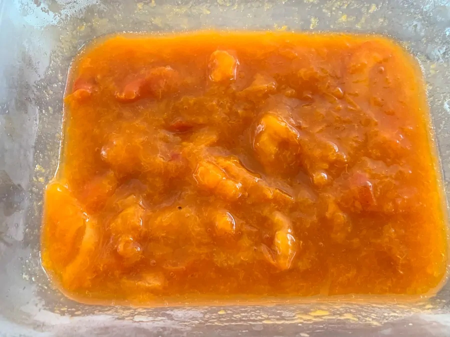 A tub of cooked apricots.