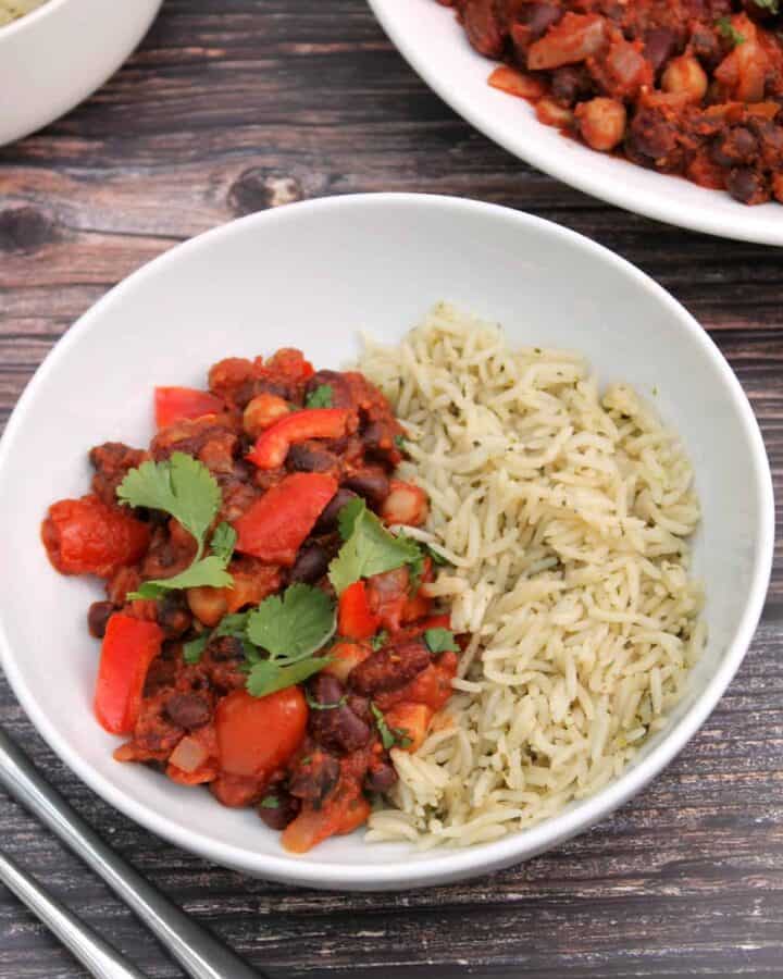 White bowl of bean chilli and rice.