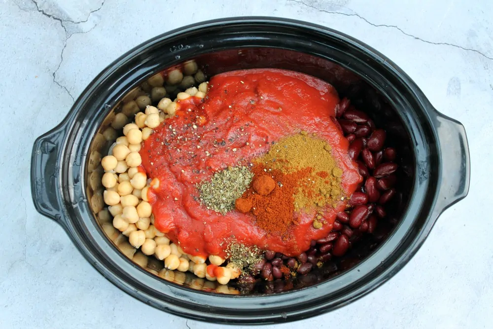 Ingredients and spices in slow cooker pot.