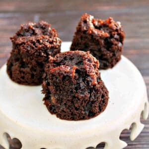 Slow cooker muffins on a small white cake stand.