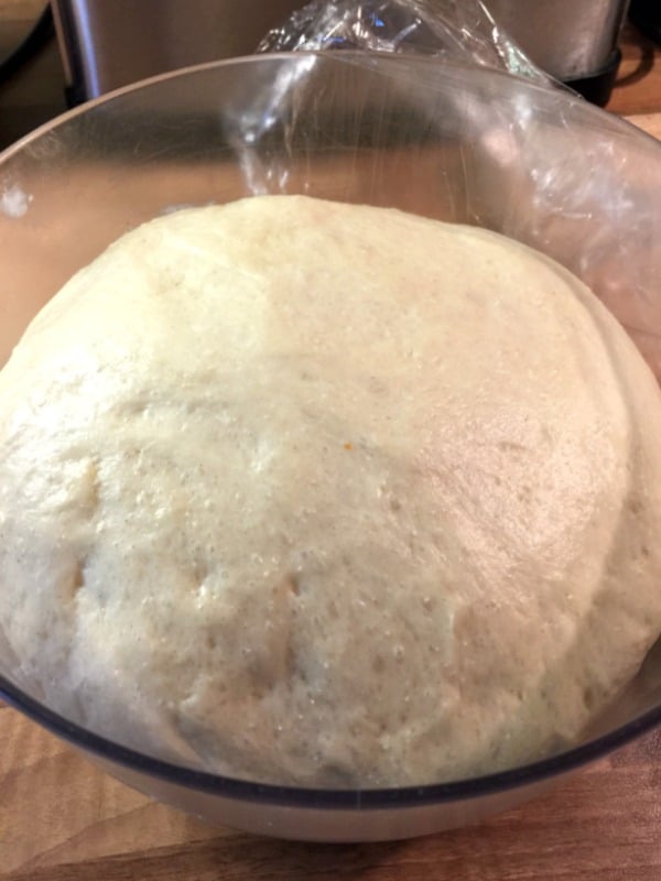 Brioche dough proving in a bowl.
