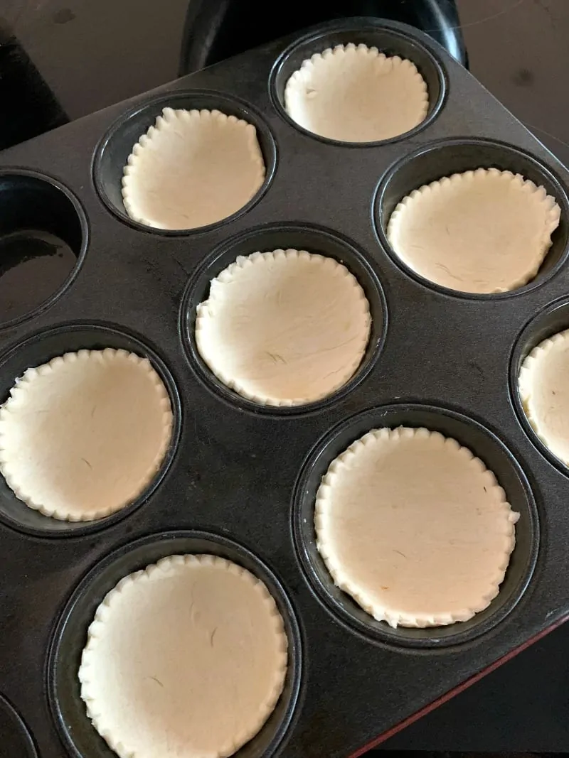 Mince pies pastry bases in a tin.