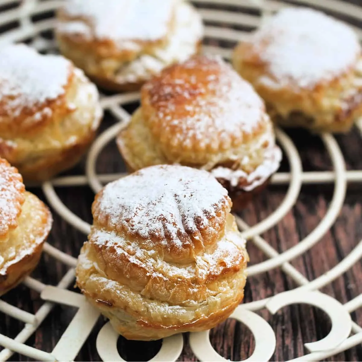 Close up of mince pies dusted with icing sugar.