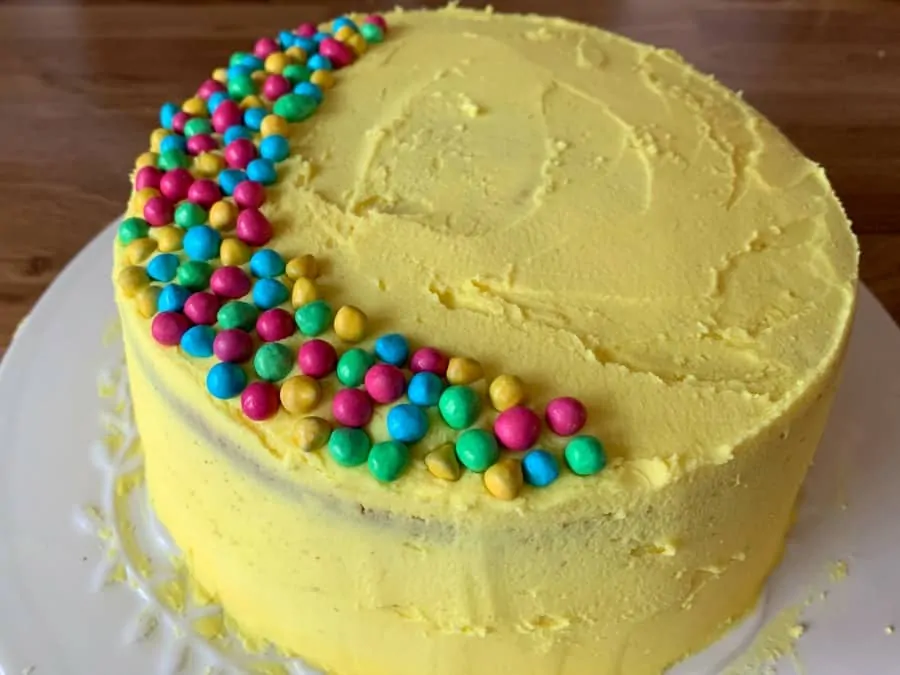 Finished cake with smooth buttercream and sprinkles.
