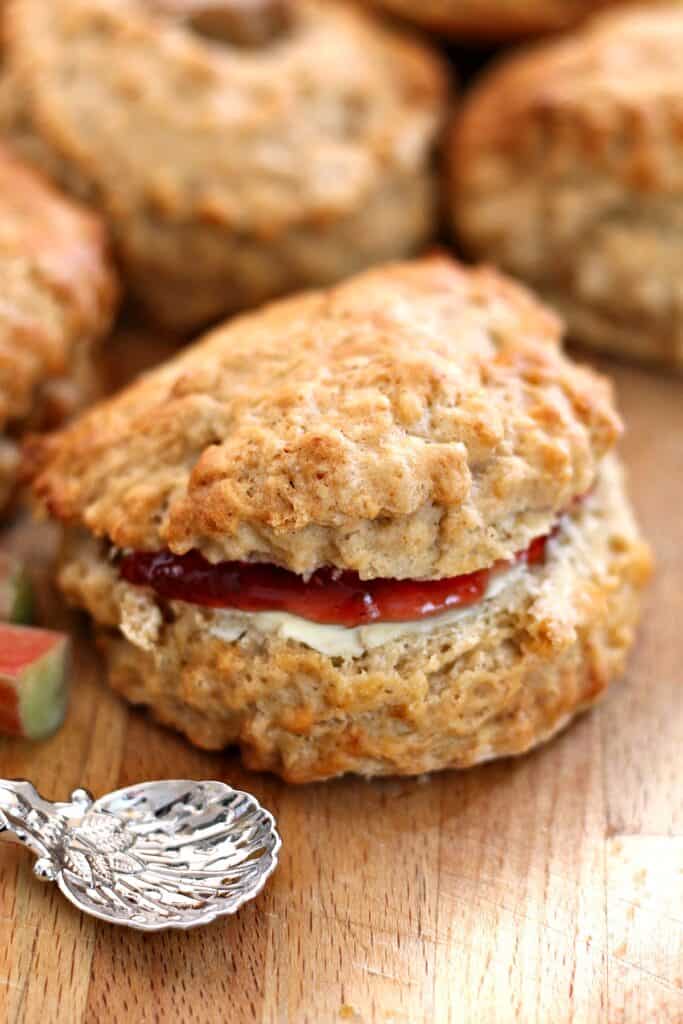 Close up of scone filled with butter and jam.
