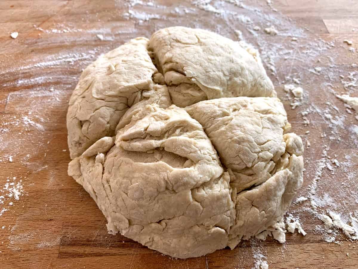 Ball of soda bread dough with two deep slashes.