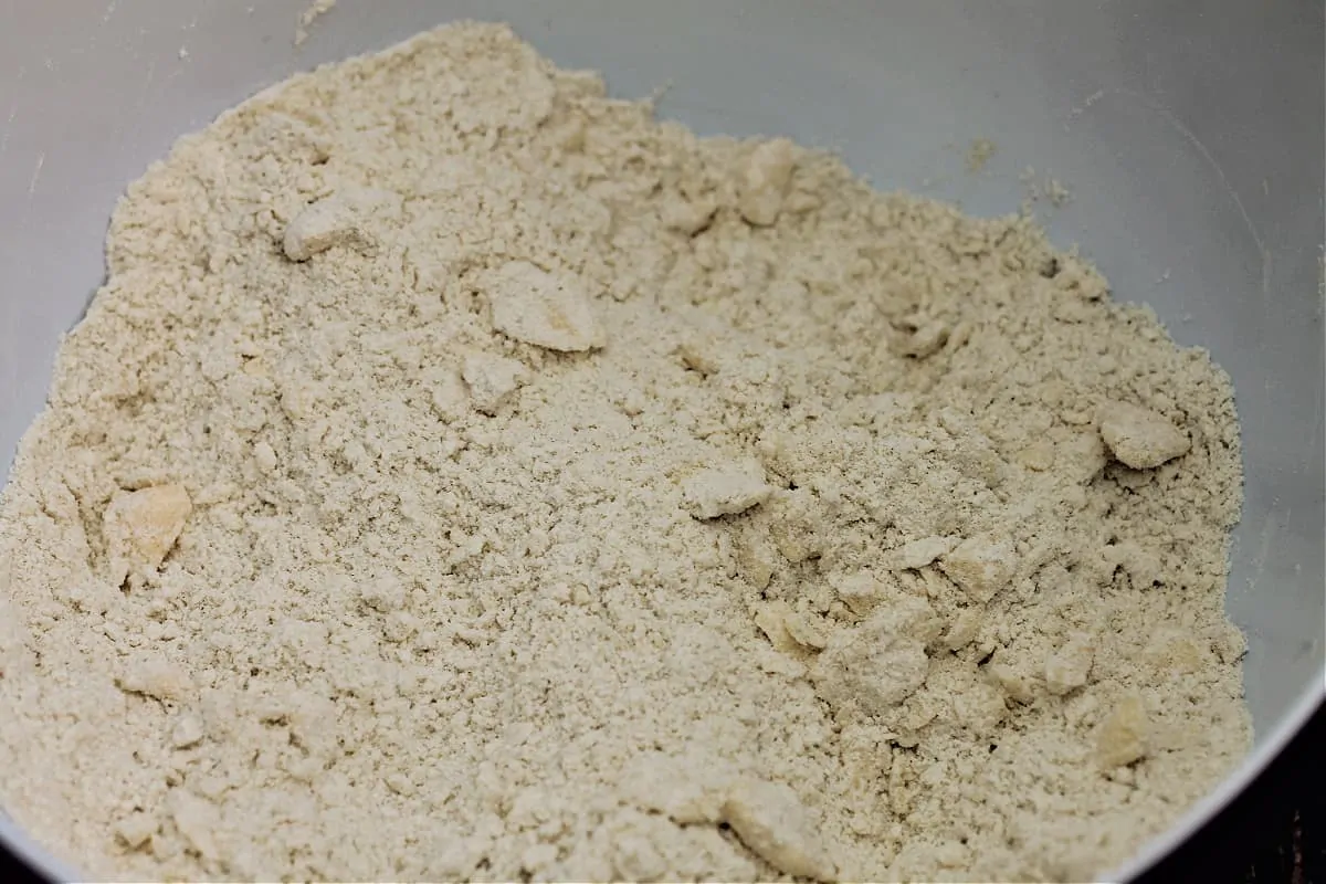 Flour with butter rubbed in to coarse breadcrumb stage in a bowl.