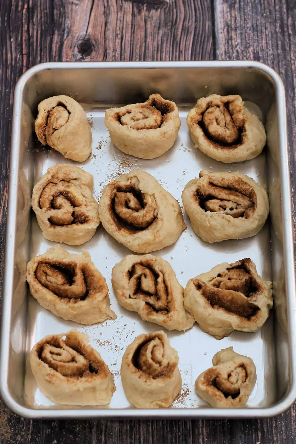 Cinnamon swirls before baking, in baking tin.