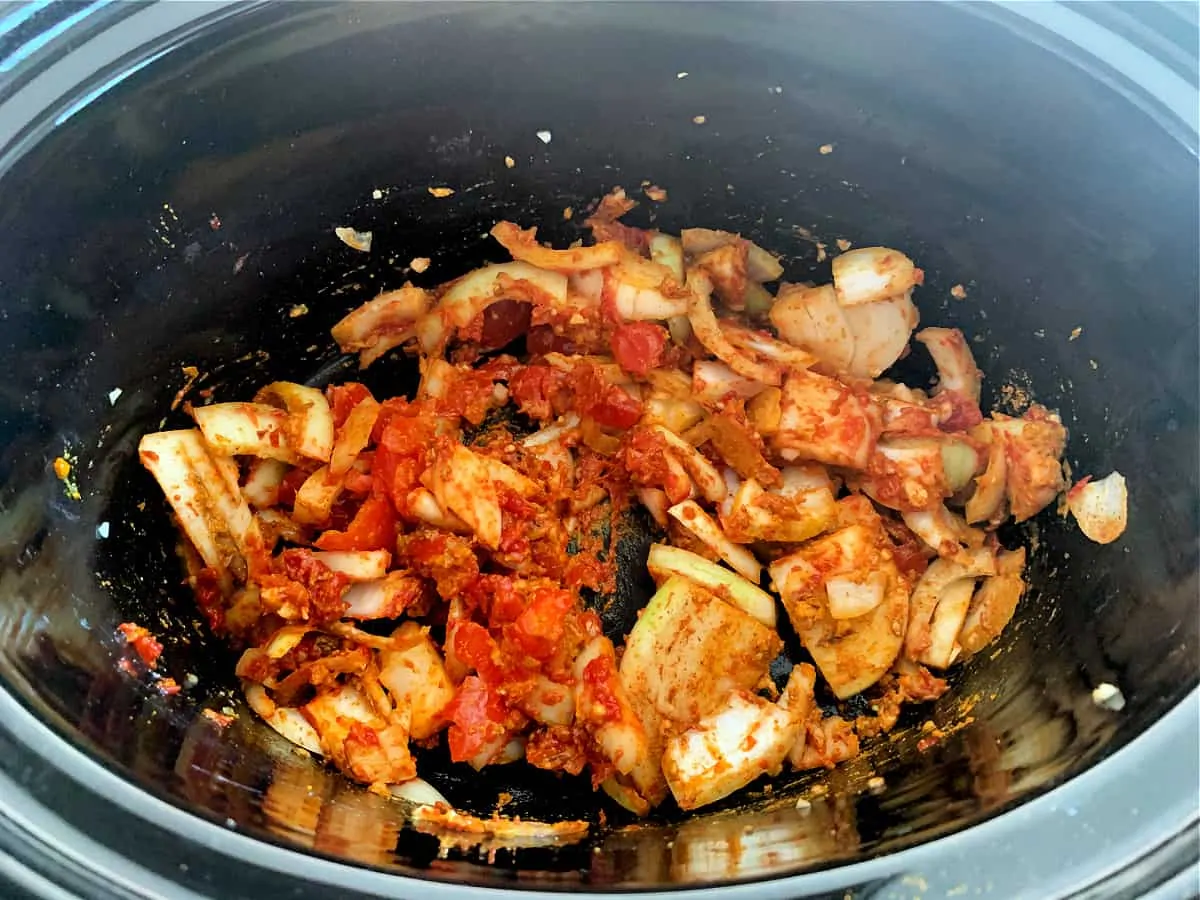 Curry base with spices in slow cooker pot.