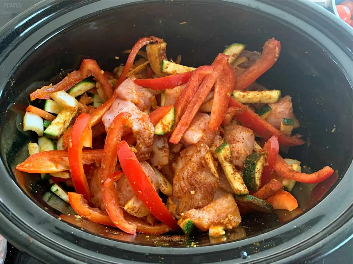 Turkey curry ingredients in slow cooker pot.