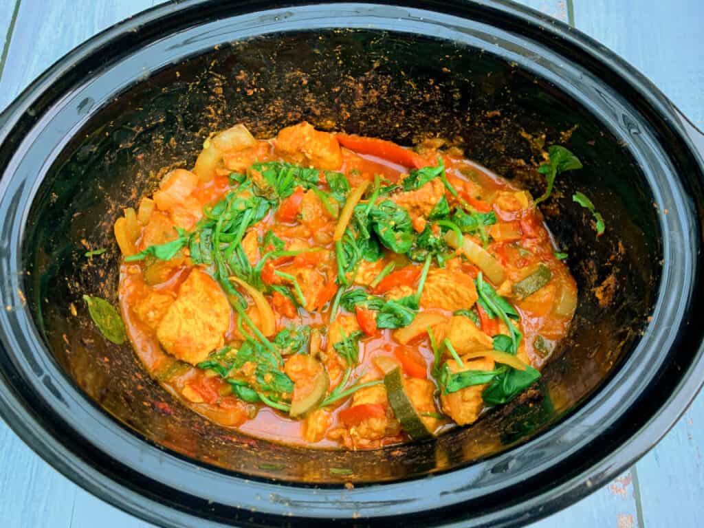 Cooked turkey curry in slow cooker pot.