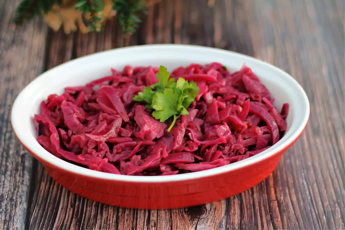 A bowl of braised red cabbage topped with parsley.