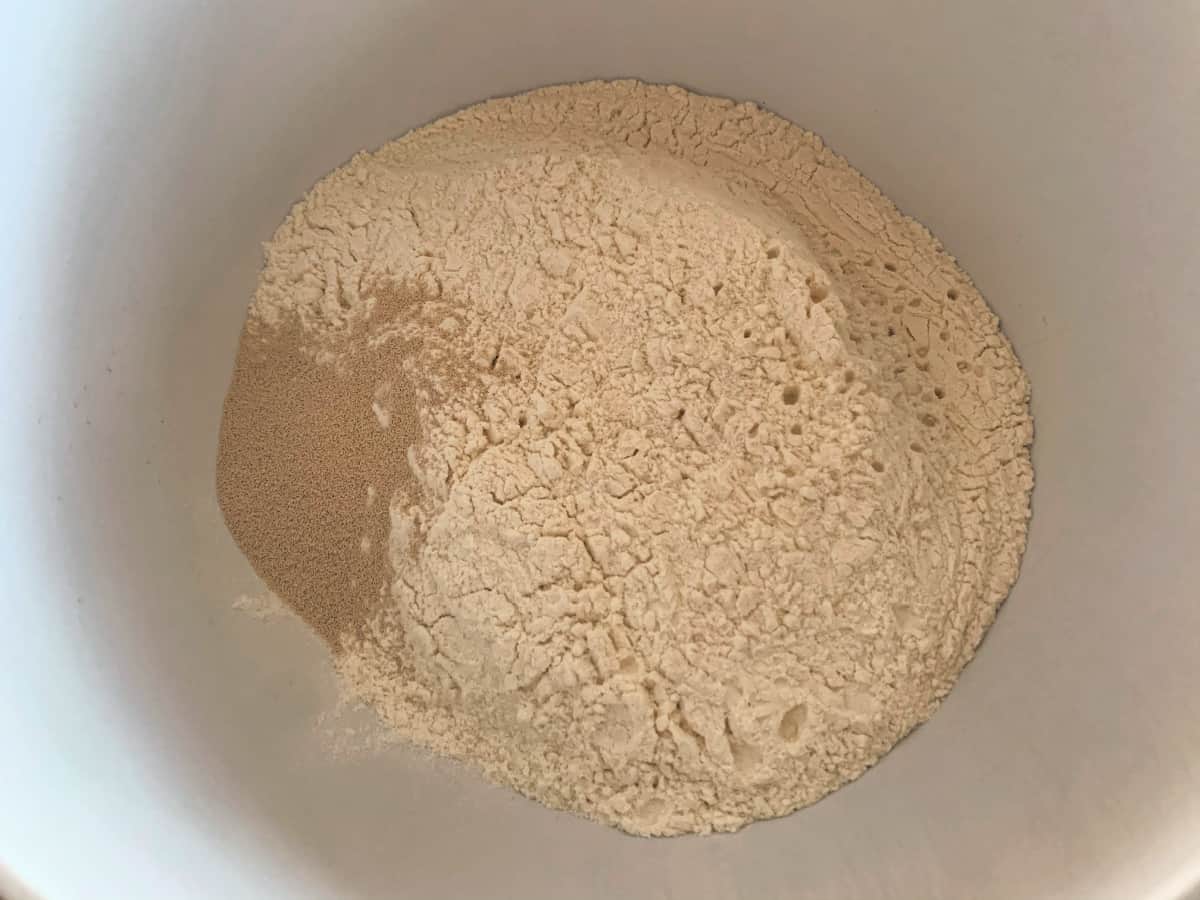 Flour, salt and yeast in a white bowl.