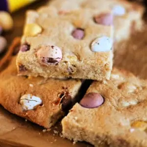 Stack of square cookie slices with Cadbury Mini Eggs.
