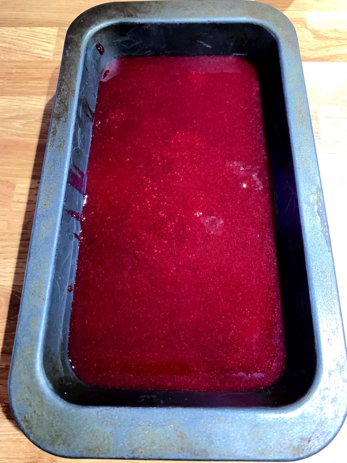 Blackcurrant sorbet in metal tin, after churning but before freezing in freezer.