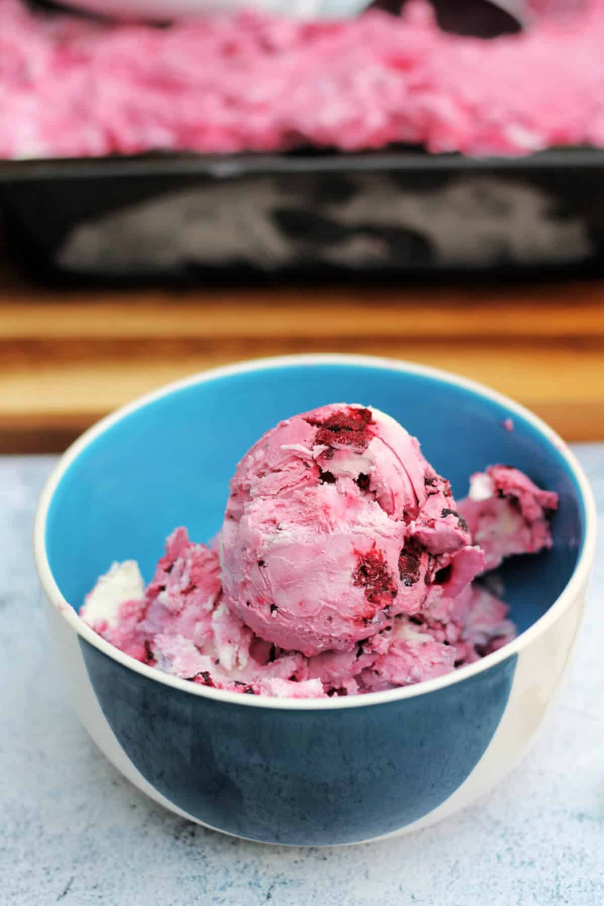 Blue bowl of pink ice cream.