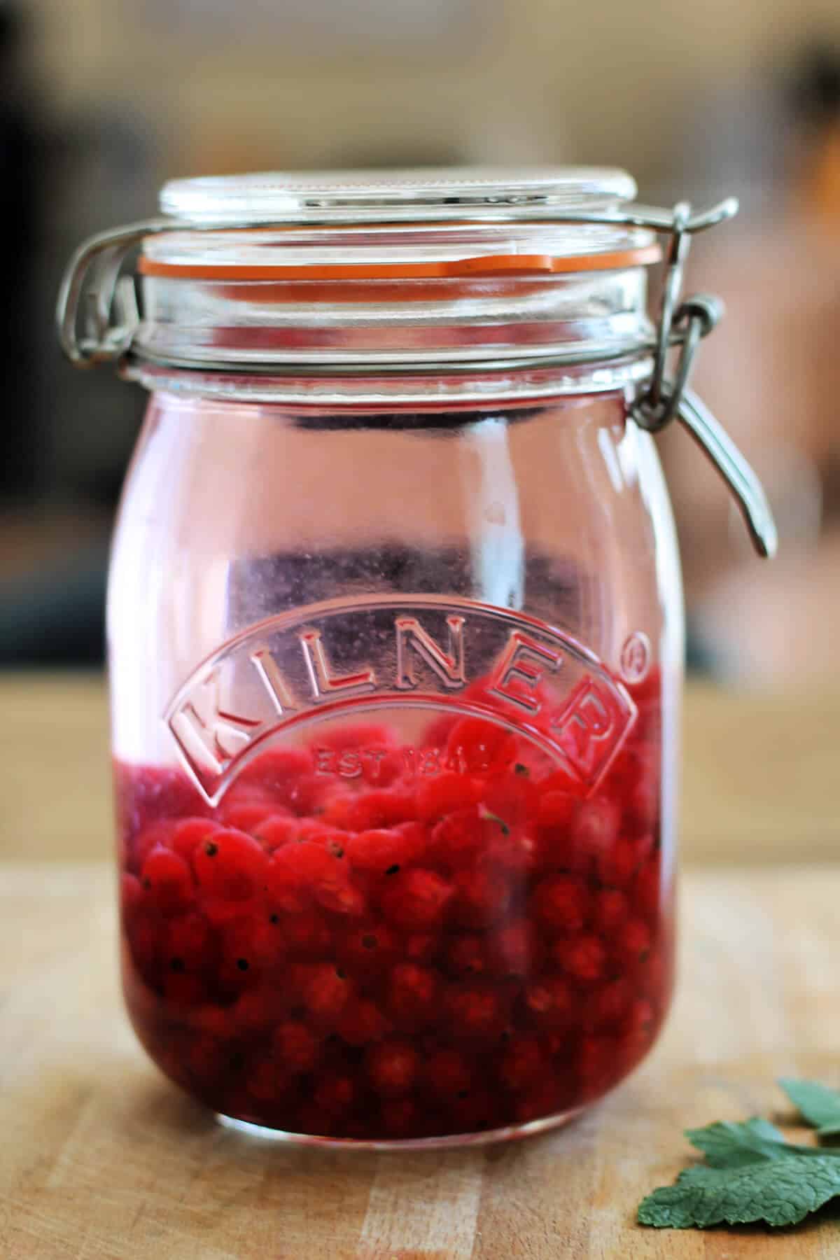 Jar of redcurrants and gin.