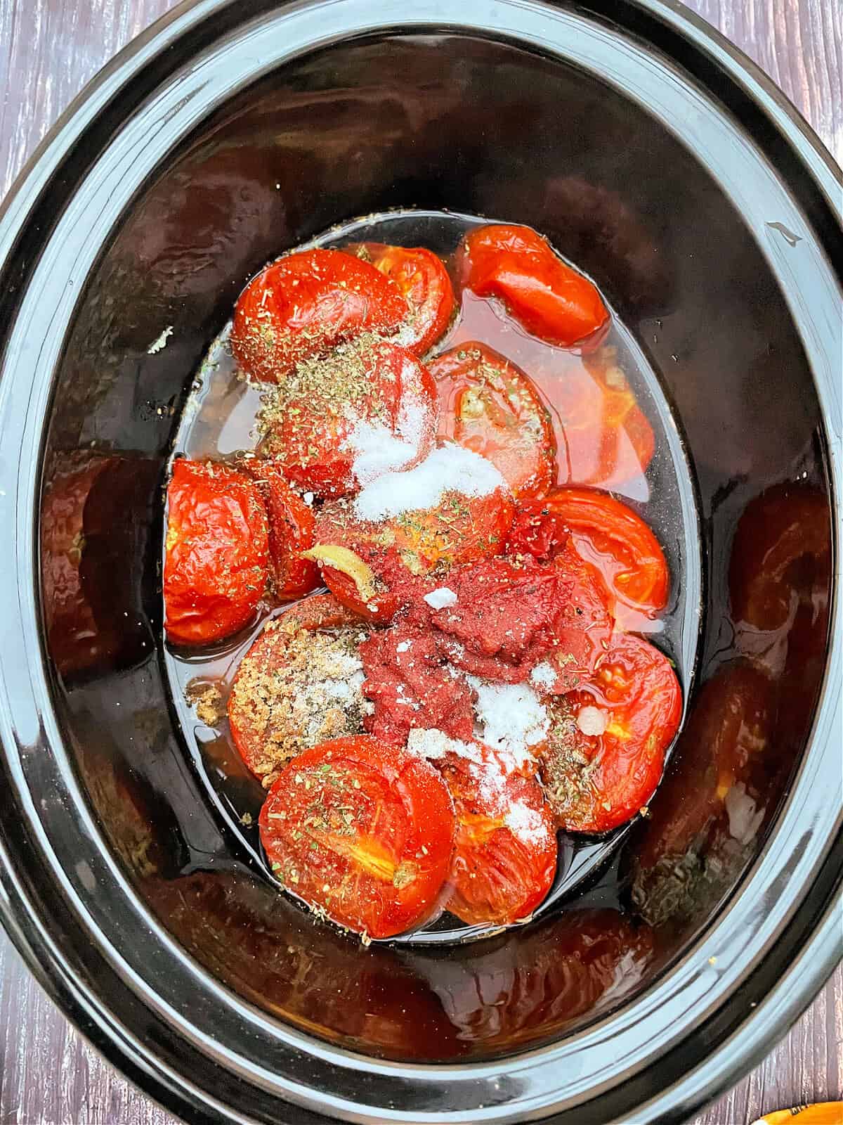 Tomato soup ingredients in slow cooker pot.