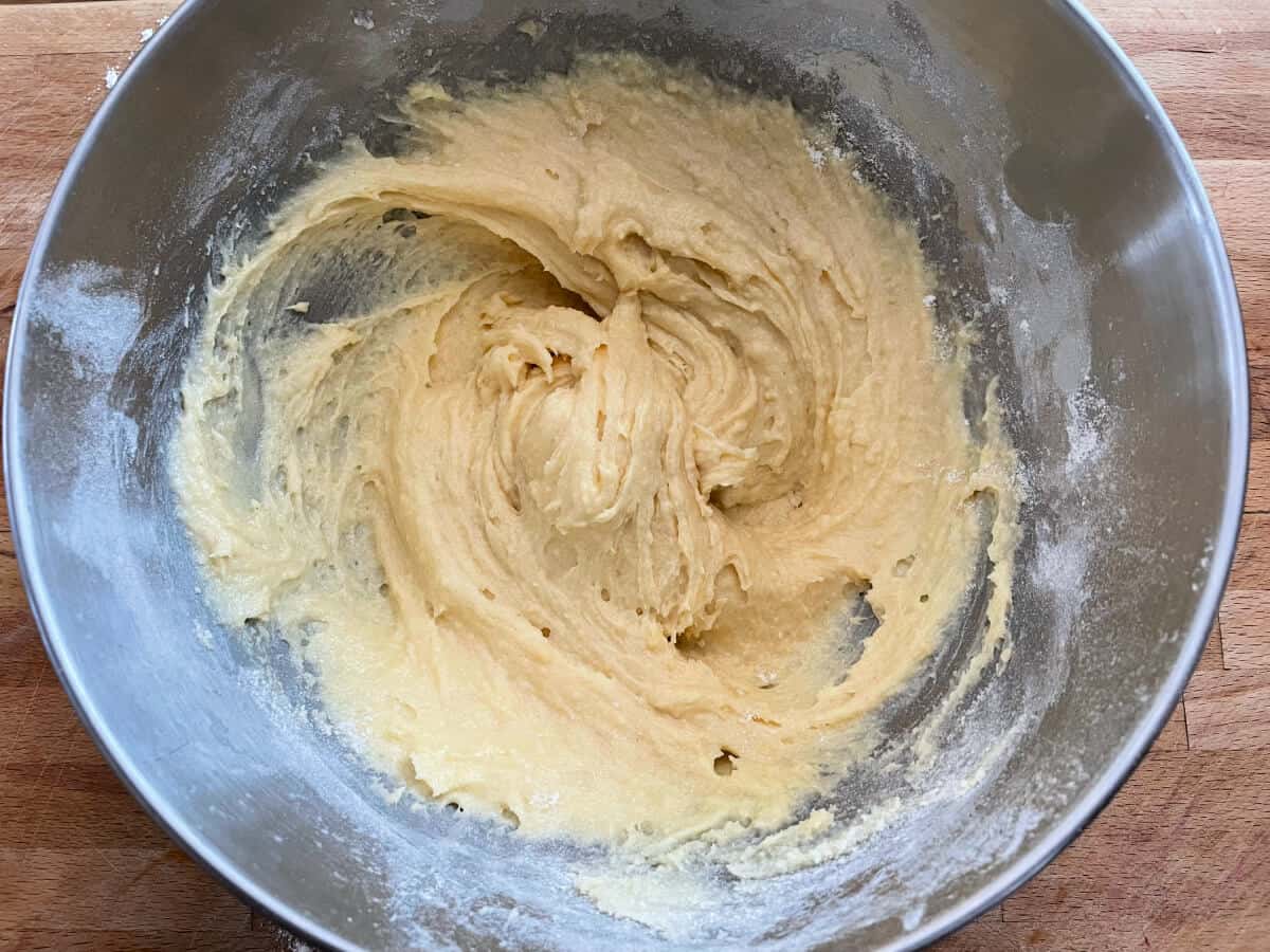 Cake mixture in a metal bowl, mixed.