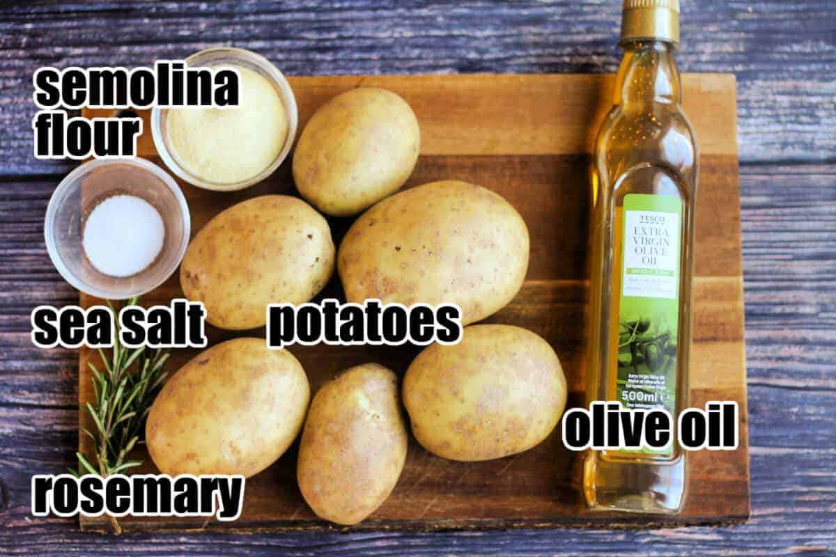 Labelled ingredients for roast potatoes on a board.