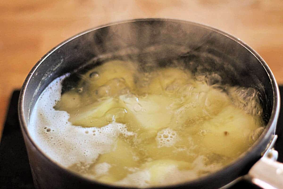 Potatoes boiling in a saucepan.