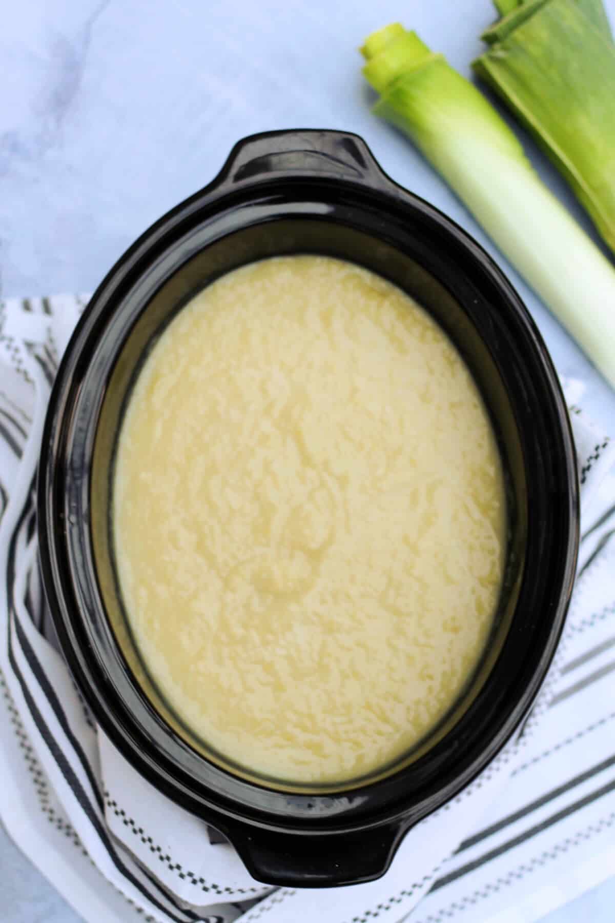 Leek soup in slow cooker pot.
