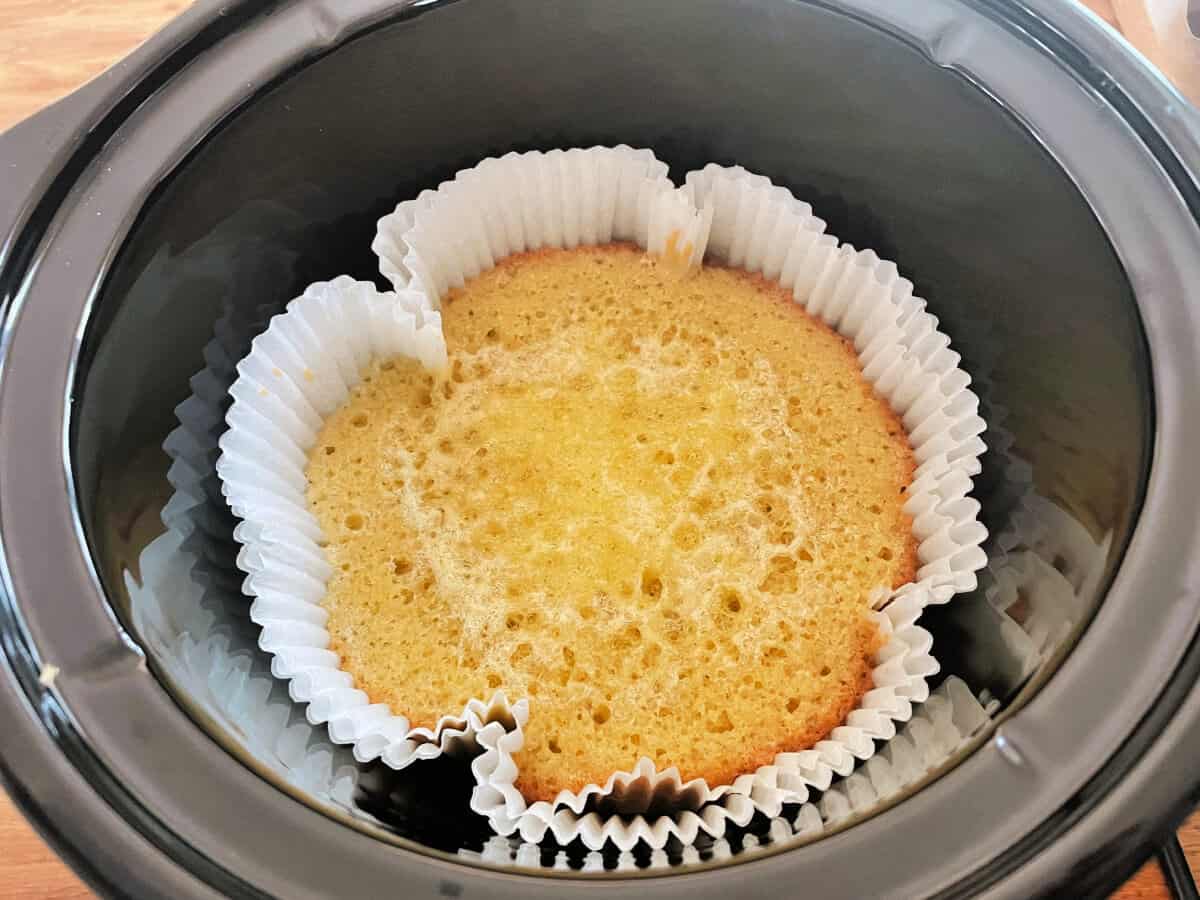 Cooked lemon cake in slow cooker pot.