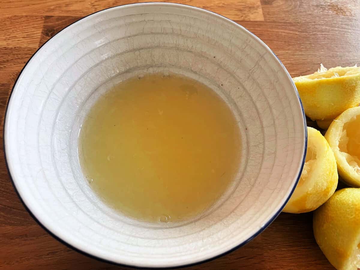 Lemon juice and sugar mixture in white bowl.