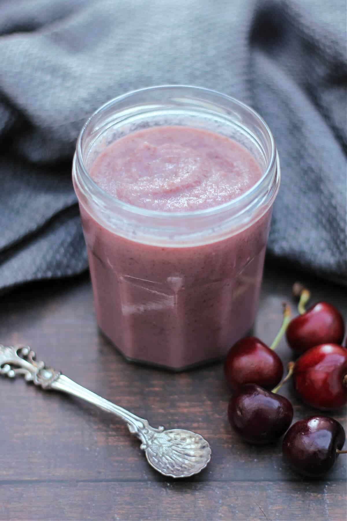 Jar of pink curd with a spoon to the side.