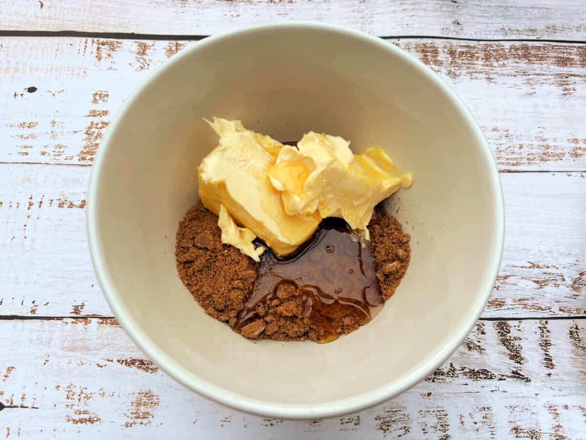 A bowl containing sugar, golden syrup and butter.