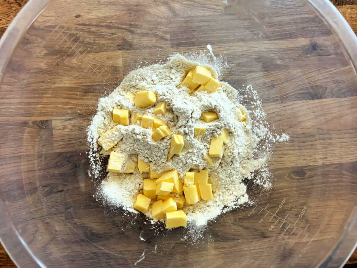 Flour and cubed butter in a mixing bowl.